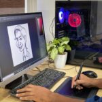 person using computer on brown wooden desk