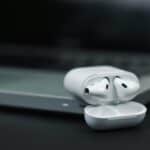 white apple earpods on black surface