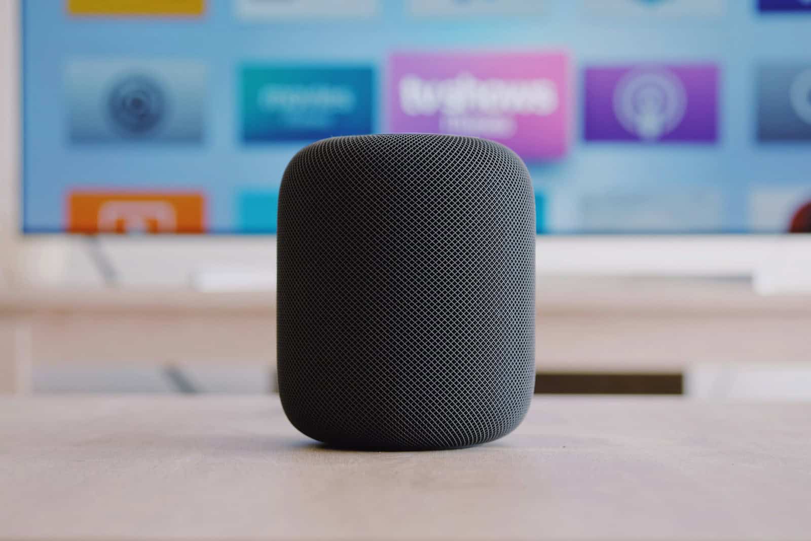black Apple HomePod speaker on table