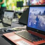 a couple of laptops sit on a table