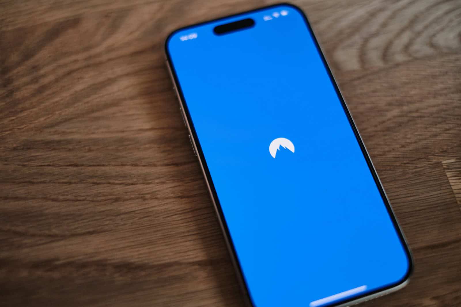 A blue phone sitting on top of a wooden table