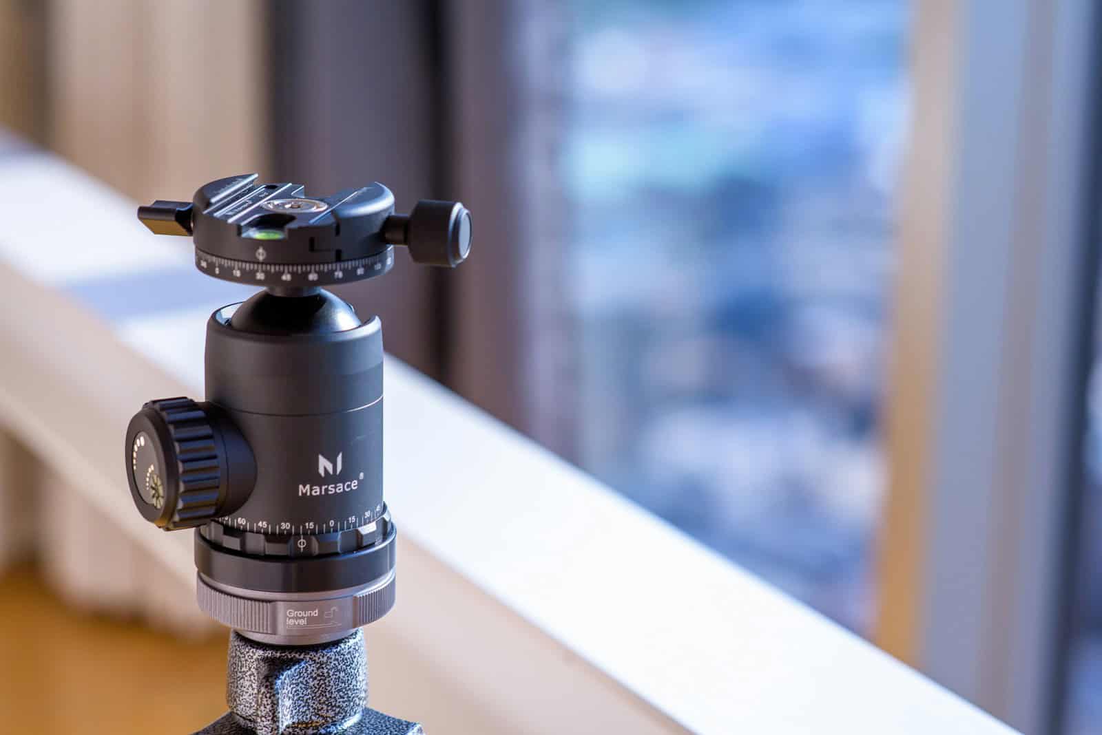 a tripod with a camera attached to it