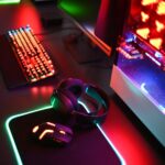 a computer with a keyboard, mouse and headphones