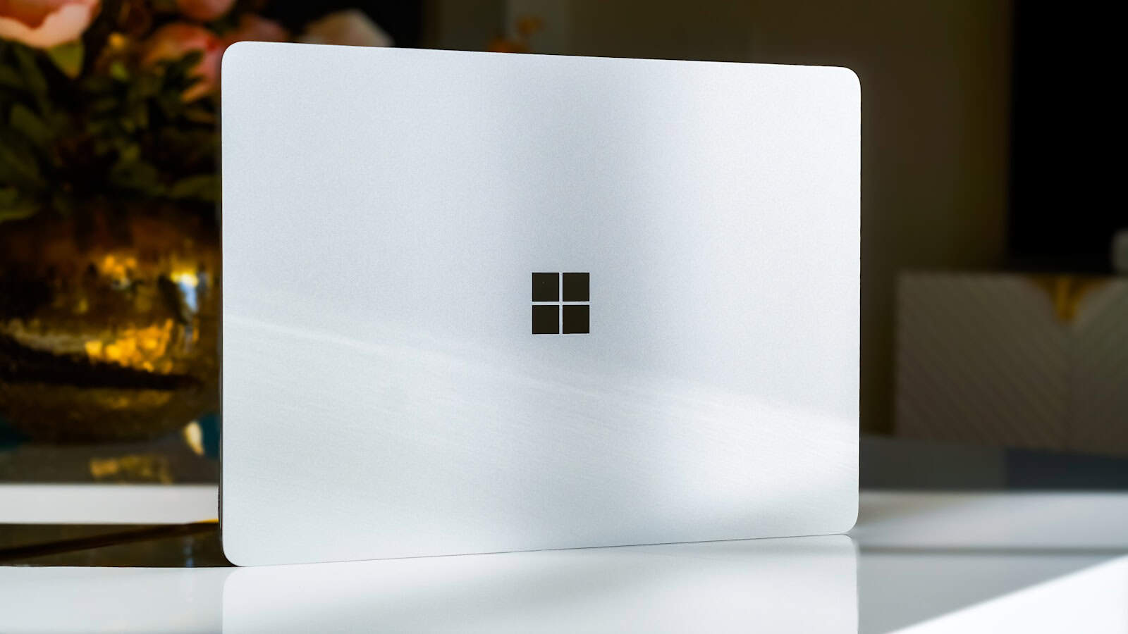 A white laptop sitting on top of a table