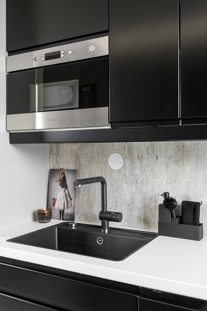 A kitchen with a sink and a microwave