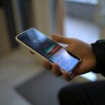 a person holding a smart phone in their hand