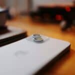 A white laptop computer sitting on top of a wooden table