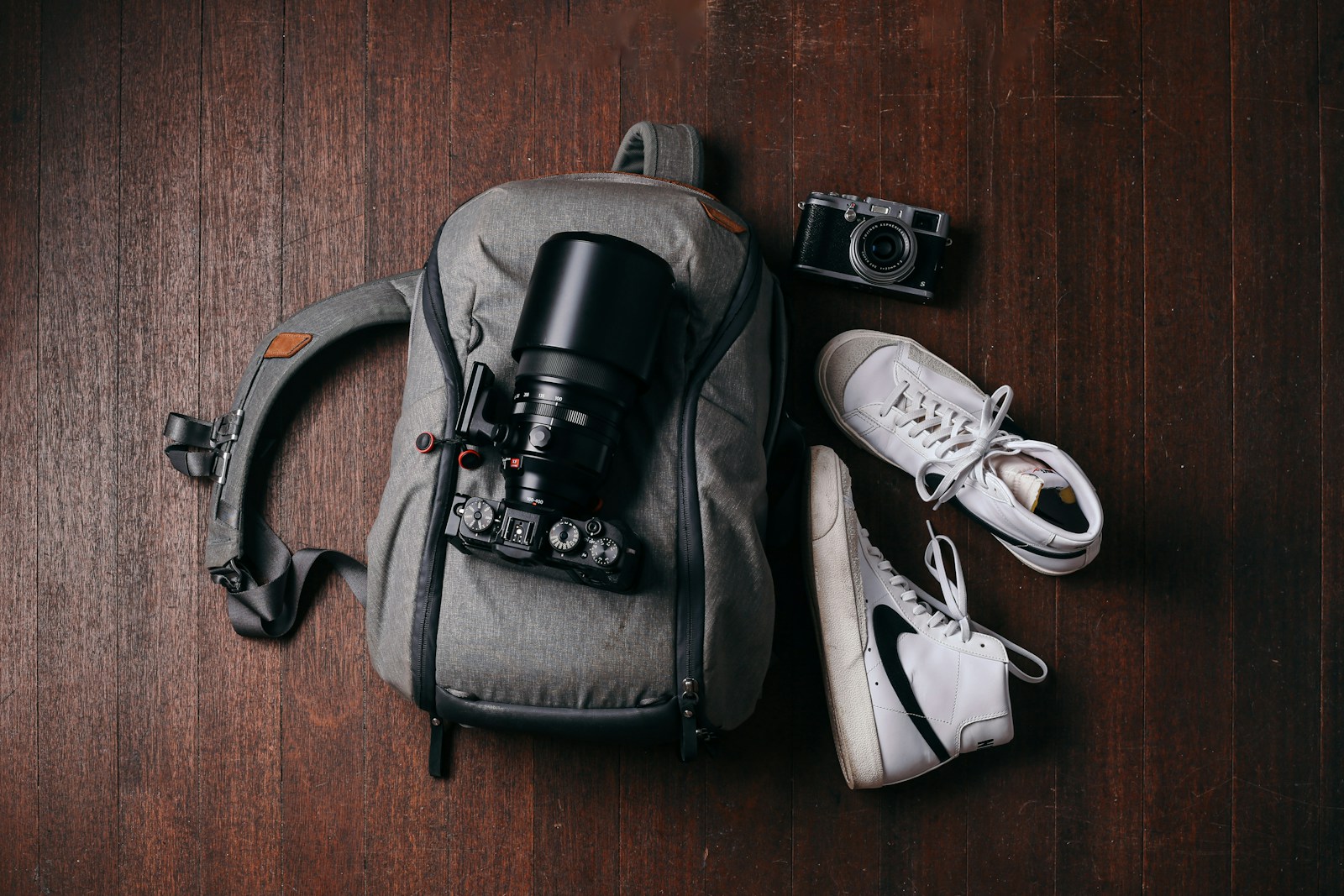 a camera and some shoes on a wooden floor