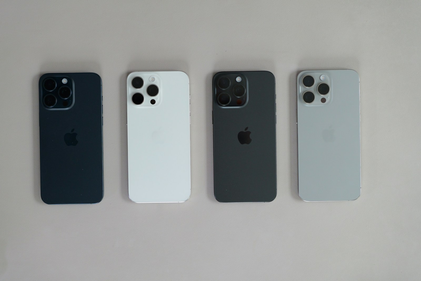 A group of four cell phones sitting next to each other