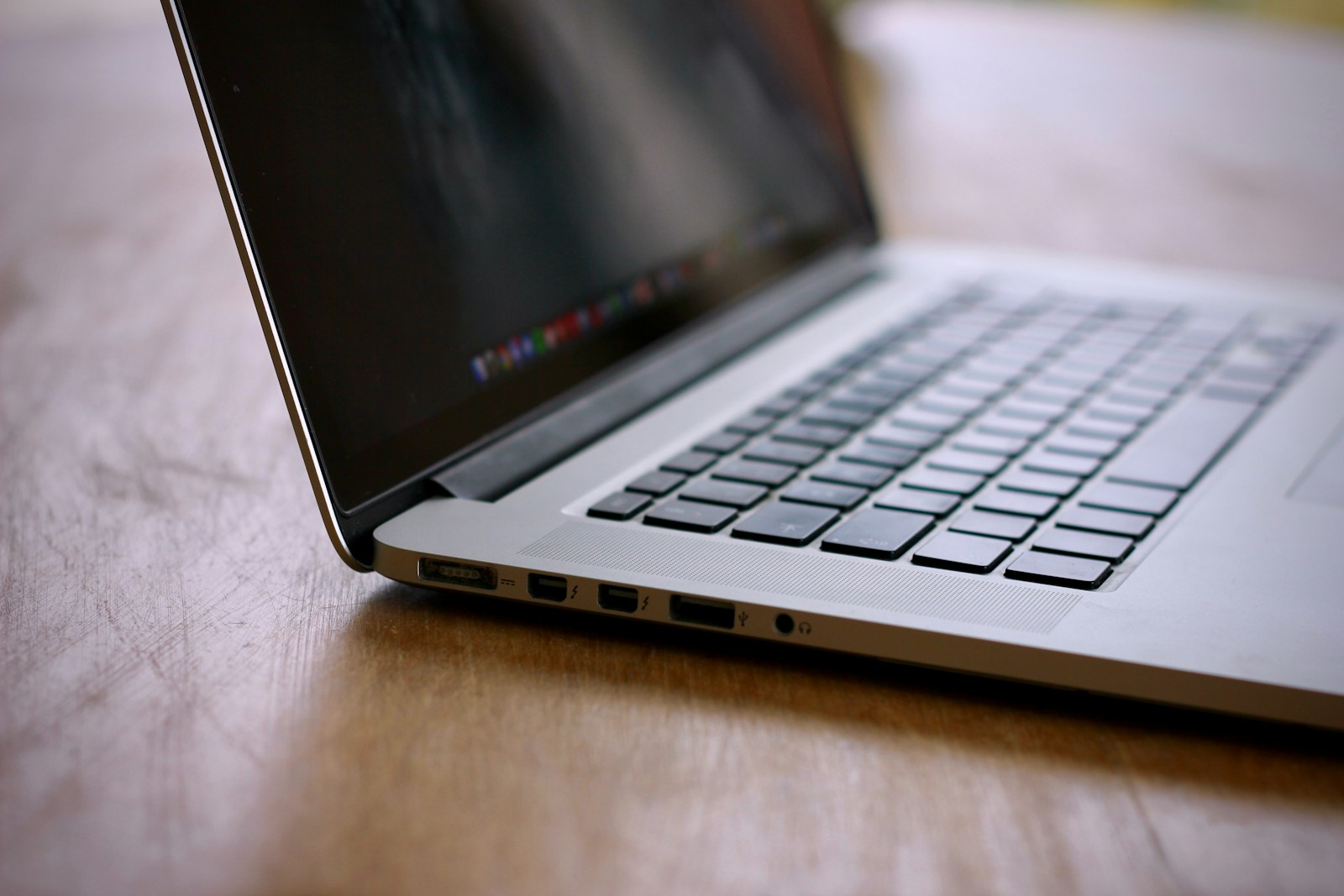 MacBook Pro on brown wooden table