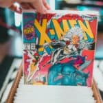 a person holding a comic book in their hand